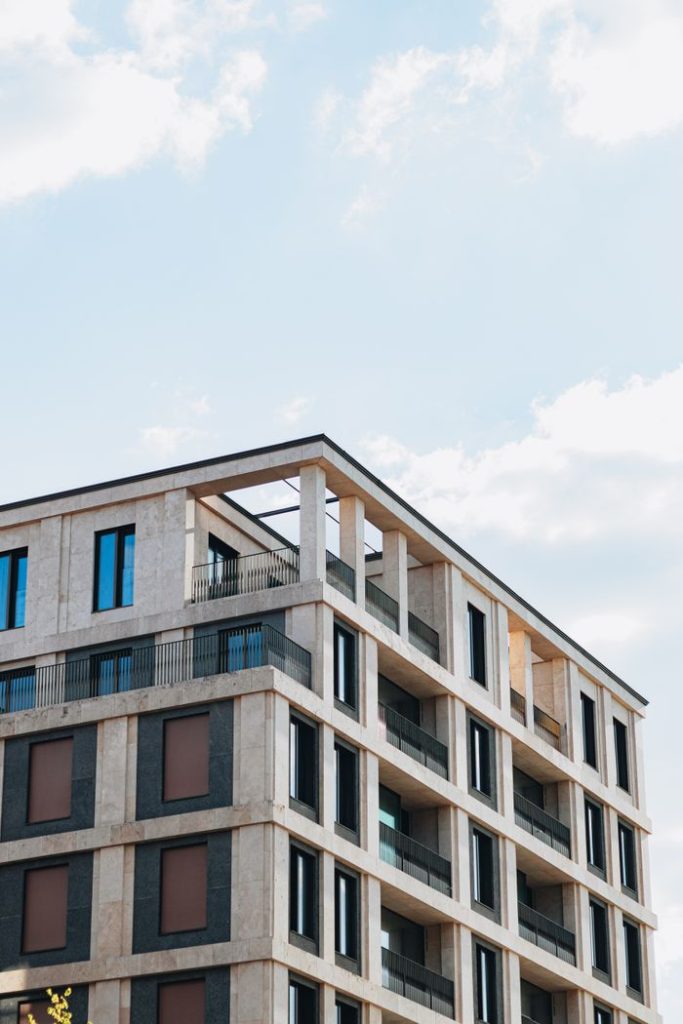 Stunning modern apartment building in Berlin showcasing contemporary architecture against a backdrop of a clear blue sky.
